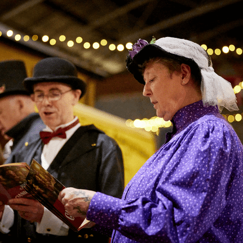 carol singes dressed in Victorian clothes